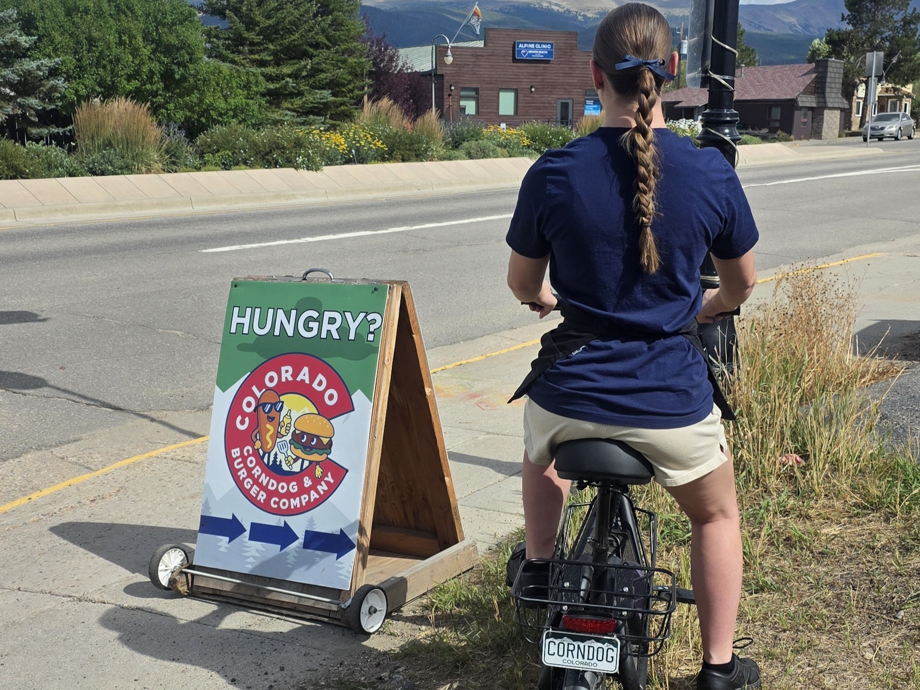 Colorado Corndog & Burger Company delivery driver on a scooter near the food truck in Fraser, Colorado